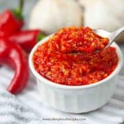 homemade Chinese chili garlic sauce scoop on a silver spoon