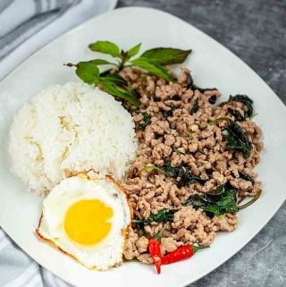 pad ka prao on a plate with rice and egg