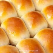 butter brushed on the freshly baked homemade soft sweet dinner rolls