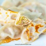 Chinese pan fried dumplings with one bit open