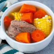 Chinese corn carrot pork soup in a white bowl