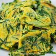 garlic chives and eggs stir fry close up on the white plate