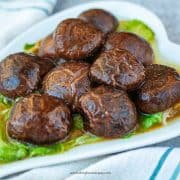 braised Chinese shiitake mushrooms served on lettuce
