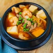kimchi-jjigae kimchi tofu stew soup in the black bowl