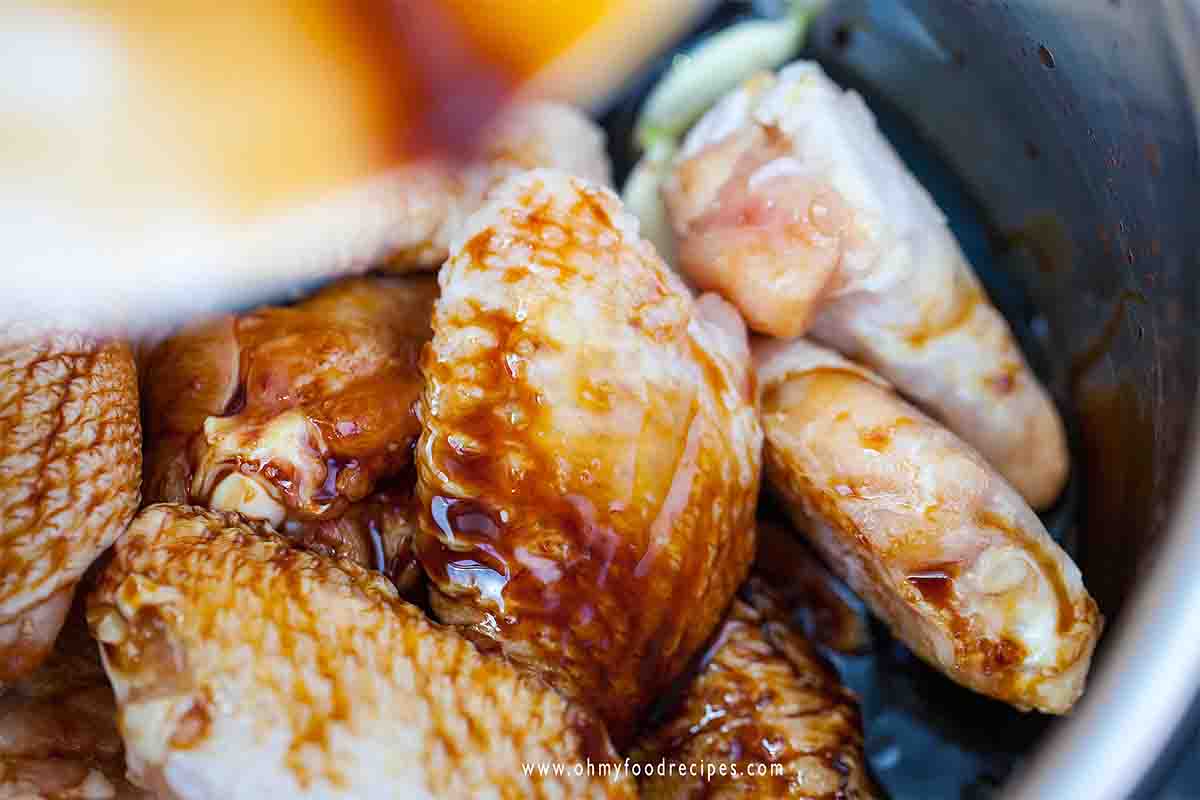 soy sauce mixture pouring into chicken wings
