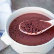 black glutinous rice dessert soup on the spoon in the bowl