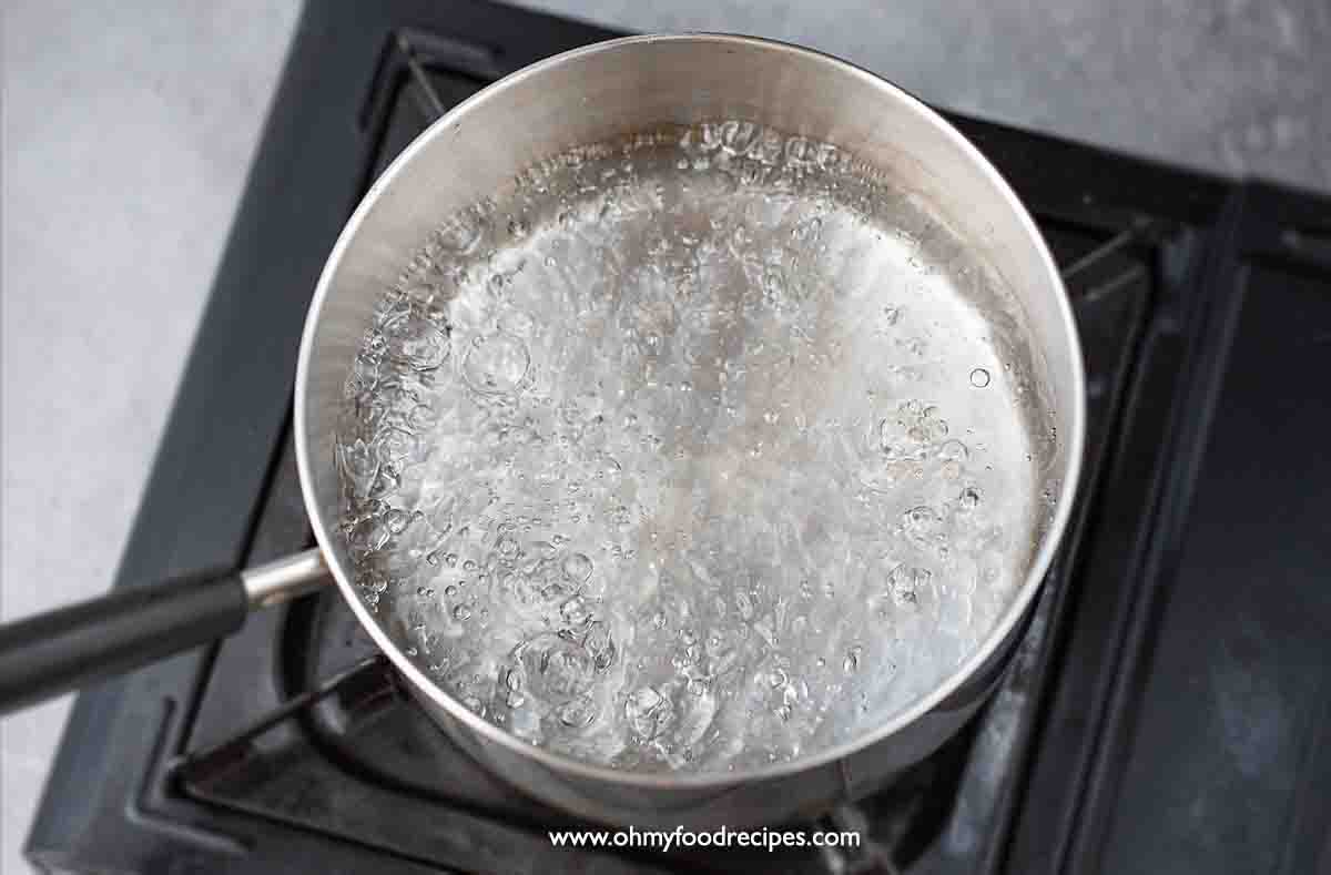 water is boiling in the pot over the stove top view