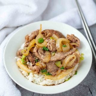 Japanese beef bowl with a silver chopsticks on a side