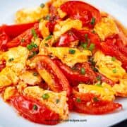 Chinese tomato egg stir fry on a white plate horizontal