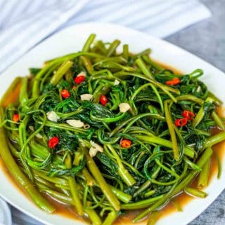 stir fried water spinach with shrimp paste on a plate