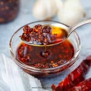 chili oil scooping on a sliver spoon