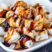 cheung fun rice noodle roll with sauce and sesame seeds close up