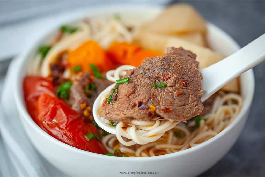 close up Taiwanese beef noodle soup noodle and beef on a spoon