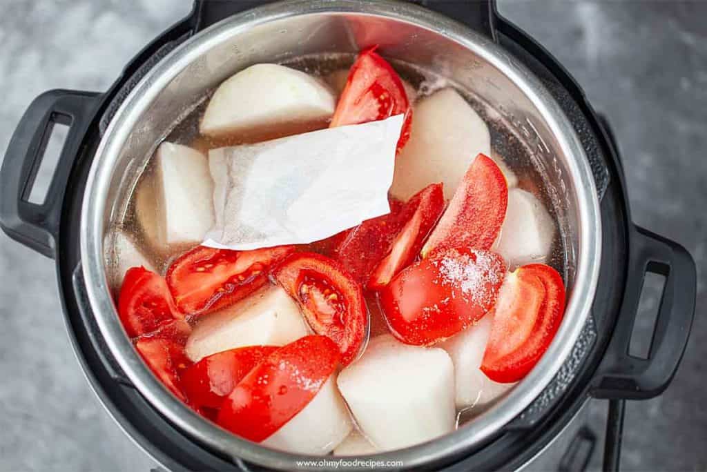 spices mixed pack and seasoning added into the pressure cooker