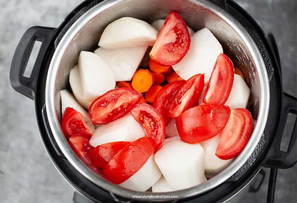 tomatoes carrot and daikon added into the instant pot