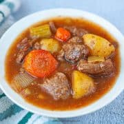 cooked beef stew in a white bowl horizontal