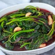 cooked red Chinese spinach in a white container