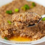 Chinese steamed minced pork with mushroom on the spoon close up