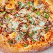 baked whole Thai chicken pizza on the stone
