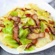 Chinese cabbage bacon stir fry on the white with a towel