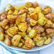 crispy roasted potatoes on a white plate horizontal
