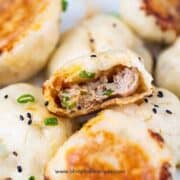 sheng jian bao or Chinese pan fried pork buns bite open