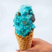 Cookie Monster ice cream in the waffle cone and hold with a hand