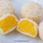snow skin mooncake with custard filling cut open half on the plate