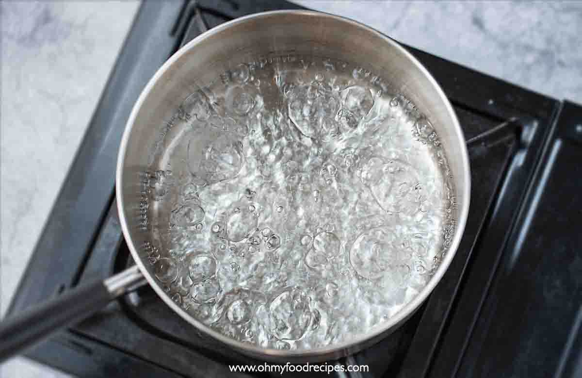 water boiling in the pot over the stove