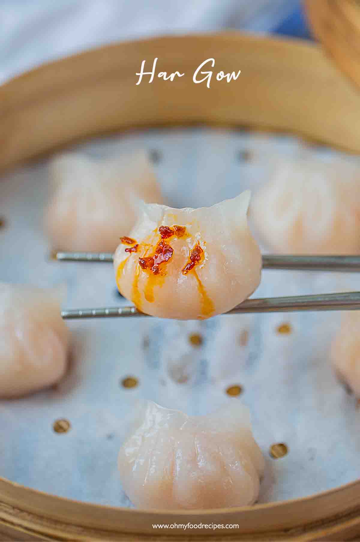 chili oil on the shrimp har gow dumpling on the silver chopsticks