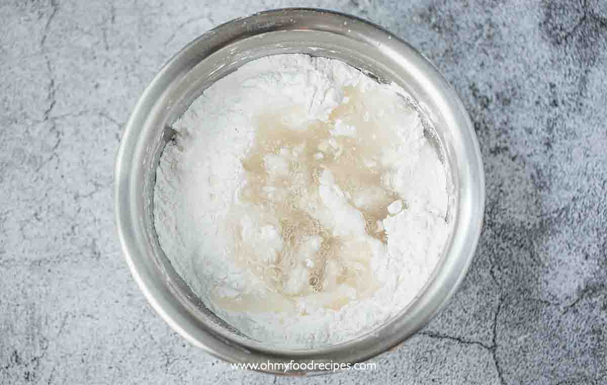 Hot boiling water poured into the starch mixture in the bowl top view