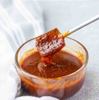 Ssamjang Korean dpping sauce in the glass container with a spoon